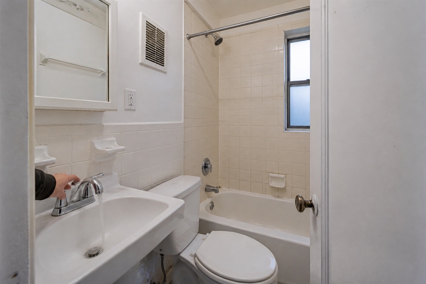 Water flow, tile, ventilation and fixtures checked in a modest NYC rental bathroom
