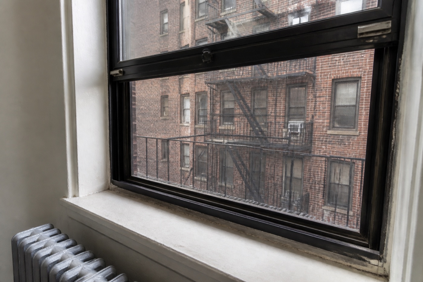 NYC rental window, weather seal, radiator and fire-escape exposure