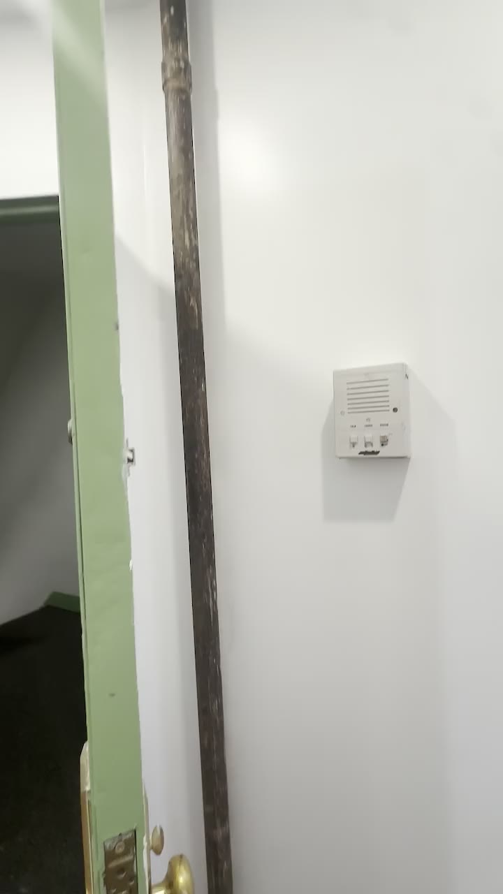 Apartment doorway and intercom documented during an in-person viewing